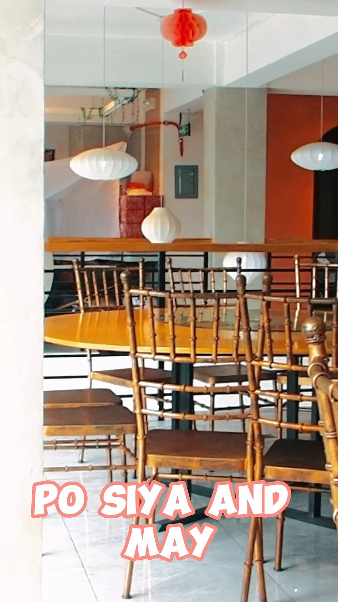Huang's Cafe dining room — two floors, lanterns, and a view