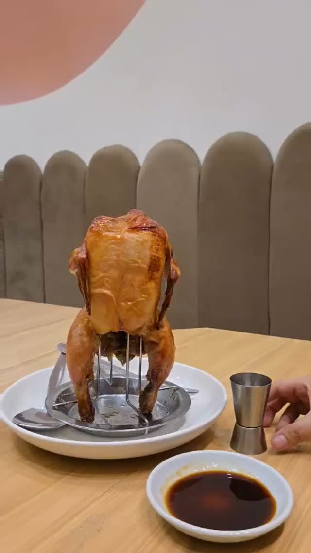 Flambe Chicken on a stand with dipping sauce — Huang's Cafe signature roast